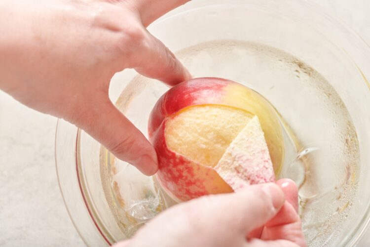 桃を氷水につけて皮をむく